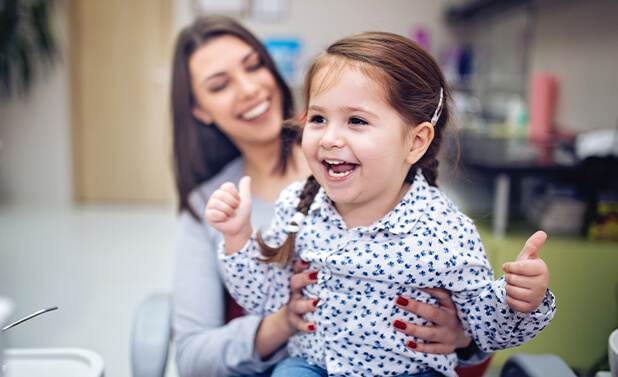 young girl at the dentist's office with her mother