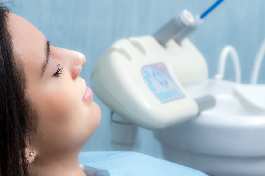 Woman relaxing in the dental chair after receiving dental sedation.