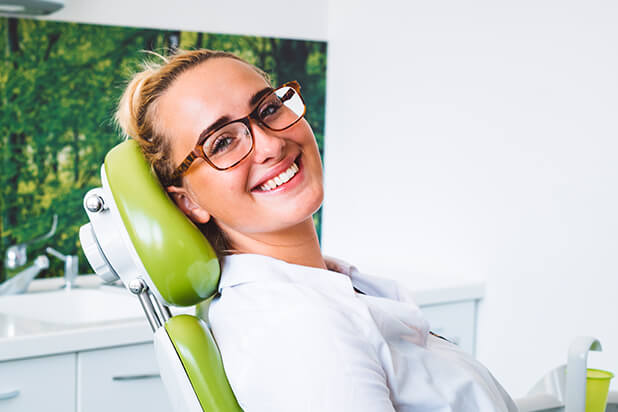 smiling young woman sitting in a dental chair