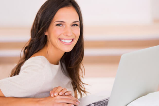 smiling woman with computer