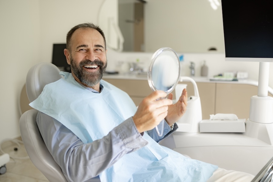 smiling man after dental implant consultation at riverstone dental care